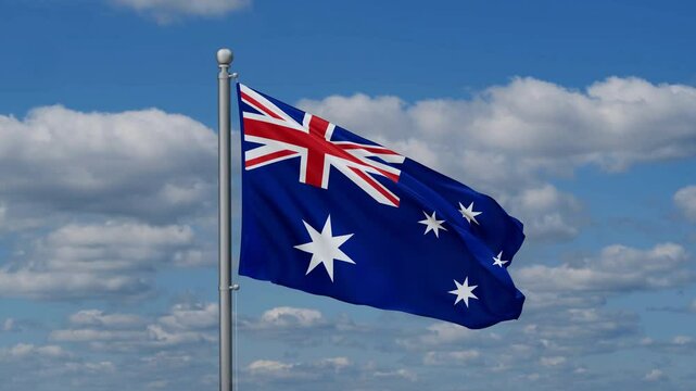 Australia flag waying in the wind against the running clouds on blue sky, close-up flag video