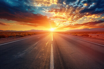 A lonely road stretching through a desert at sunset