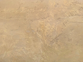 Beige or cream yellow textured paint washed on a wall or panel, seamless texture, random texture. No people.