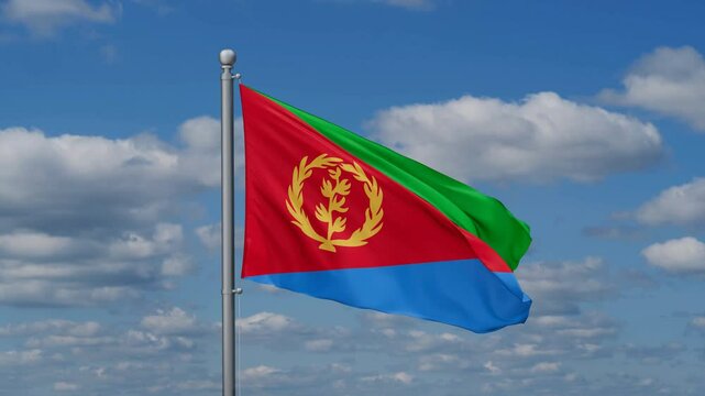 Eritrea flag waying in the wind against the running clouds on blue sky, close-up flag video