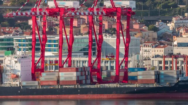 Container ship loading and unloading in sea port timelapse. Aerial view of business logistic import and export freight transportation. Cargo freight ship with red cranes in port of Lisbon, Portugal