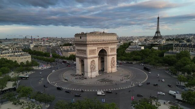 Paris Arc de Triomphe Triumphal Arch at Chaps Elysees at night, Paris, France. Drone view, Eiffel Tower in the background.  Architecture and landmarks of Paris. Postcard of Paris
