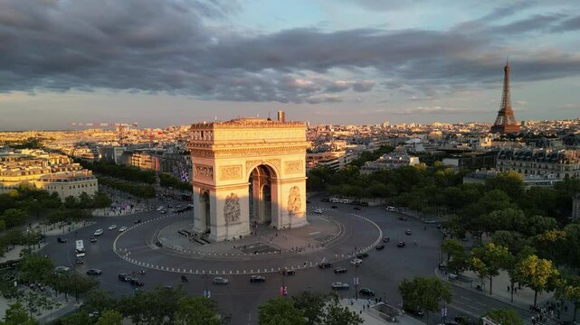 Paris, Arc de Triomphe Triumphal Arch at Chaps Elysees at night, Paris, France. Drone view, Eiffel Tower in the background.  Architecture and landmarks of Paris. Postcard of Paris
