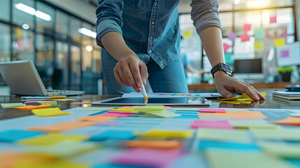 Team Collaboration Concept: Person Working on Project with Sticky Notes and Tablet   Exciting Teamwork and Creativity Symbolized with Copy Space for Writing on Photo Stock.