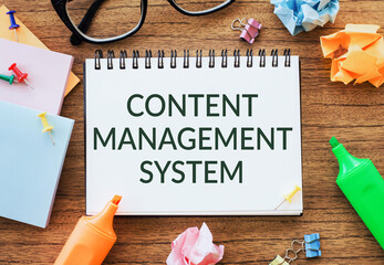 Content Management System Written On A Notebook On A Wooden Desk