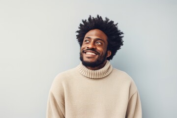 Obraz premium Portrait of a glad afro-american man in his 30s wearing a cozy sweater isolated in plain white digital canvas