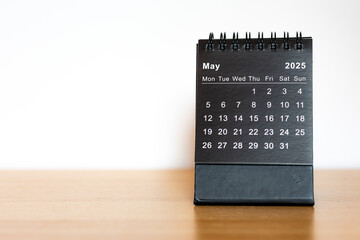 May 2025 calendar - month page on the wooden desk