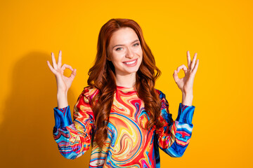 Photo portrait of lovely young lady show okey approve dressed stylish colorful garment isolated on orange color background