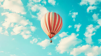 A hot air balloon floating in the sky with white clouds