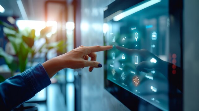 Close up on a woman's hand adjusting settings on a smart control panel, representing energy efficiency and comfort. The company's offices are equipped with automatic lighting and temperature control.