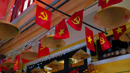  hanging Vietnamese flags banner on the top in in Hoi An night market