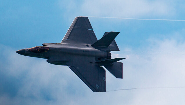 F-35 Lightning II Fighter Jet Flying Against a Blue Sky With Clouds