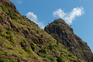 landscape of green mountains with blue sky