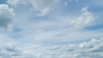 Beautiful sky background. Abstract look of natural white cumulus and cirrus clouds showing wind direction on blue sky. Timelapse.