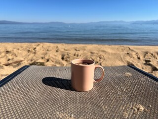 cup of coffee on Lake Tahoe beach