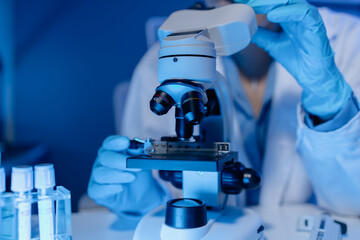 scientist is using microscope in laboratory, chemical researcher works in chemistry with concentration, chemist is conducting a science experiment using a microscope to test experimental substances