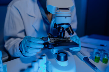 scientist is using microscope in laboratory, chemical researcher works in chemistry with concentration, chemist is conducting a science experiment using a microscope to test experimental substances