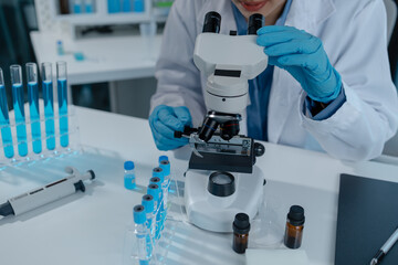 scientist is using microscope in laboratory, chemical researcher works in chemistry with concentration, chemist is conducting a science experiment using a microscope to test experimental substances