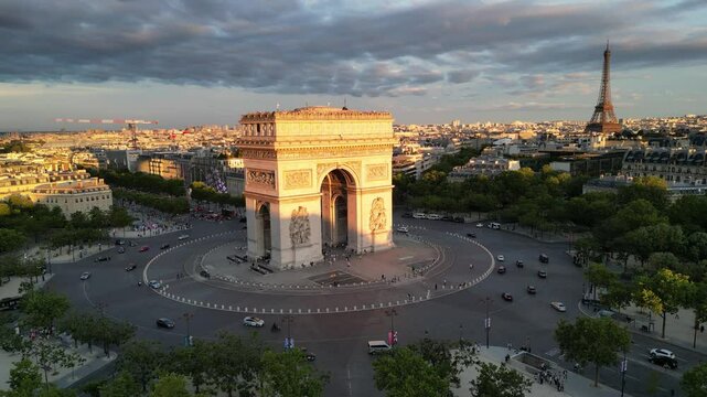 Paris, Arc de Triomphe Triumphal Arch at Chaps Elysees at night, Paris, France. Drone view, Eiffel Tower in the background.  Architecture and landmarks of Paris. Postcard of Paris

