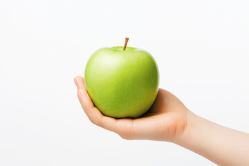 A hand holding a green apple