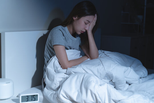 Anxiety disorder on insomnia woman concept, sleepless Woman open eye awakening on the bed at night time can't sleep from symptom of depression diseased.