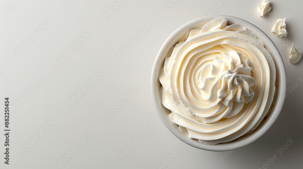 Poster  A bowl overflowing with whipped cream rests on a pristine countertop, nearby, a mound of whipped cream awaits