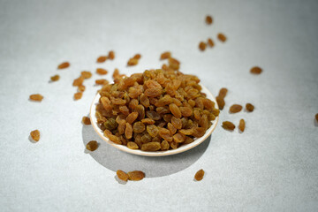 Raisins are placed on a bowl..