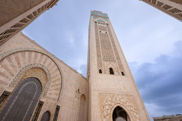 A low angle view of the towering minaret of the Hassan II Mosque, with its ornately patterned...