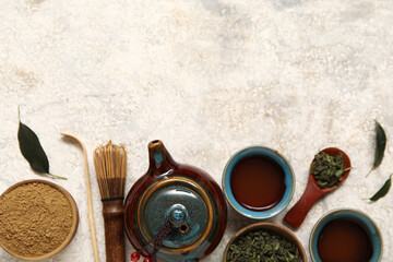 Japanese traditional teapot with cups of puer tea and powdered matcha on white background