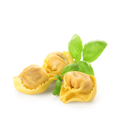 Raw dumplings and basil on white background