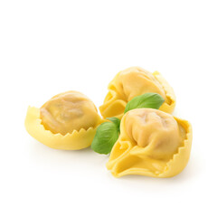 Raw dumplings with basil on white background