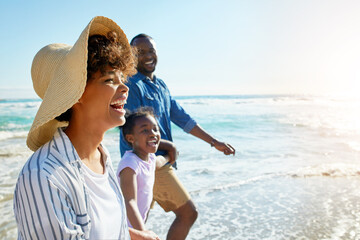 Ocean, family and beach for walk, laugh and waves for relax on seaside holiday. Parents, child or...