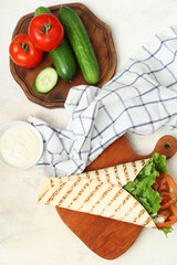 Composition with tasty doner kebab on light background