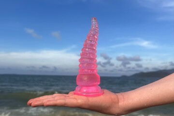 adult sex toy, pink octopus tentacles, toy from Japan, sea backround
