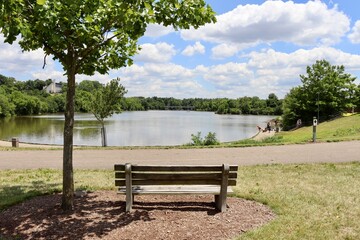 The park bench overlooking the lake in the park.