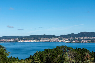 Fototapeta premium Panoramic view of the fishing village of Cangas in the Vigo estuary from the O Castro mountain. Galicia, Spain.