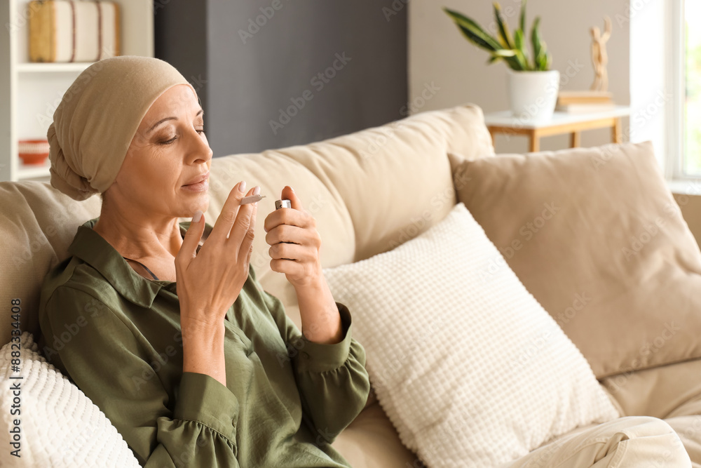 Sticker Mature woman after chemotherapy lighting up joint with weed on couch at home