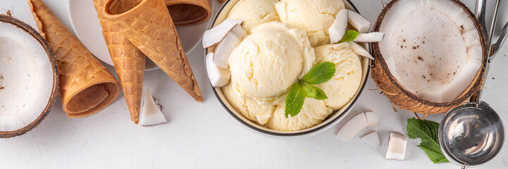 Vegan creamy coconut sorbet ice cream. Bowl with classic white coconut flavor non-dairy vegetarian gelato made with coconut milk, creamy frozen summer dessert