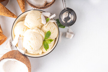 Vegan creamy coconut sorbet ice cream. Bowl with classic white coconut flavor non-dairy vegetarian gelato made with coconut milk, creamy frozen summer dessert