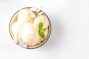Vegan creamy coconut sorbet ice cream. Bowl with classic white coconut flavor non-dairy vegetarian gelato made with coconut milk, creamy frozen summer dessert
