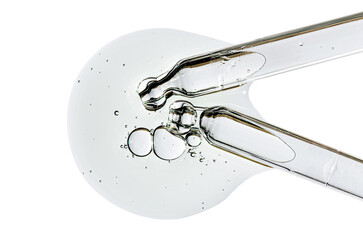Two pipettes and a drop of cosmetic serum for the skin. Liquid body care product. Macrophotography....