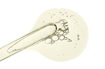 Pipette and a drop of cosmetic serum for the skin. Liquid body care product. Macrophotography....