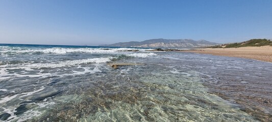 The crystal clear water of the Aegean sea on a beach in Rhodes, Greece