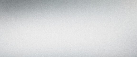 Softly lit fine grained surface of brushed metal texture background