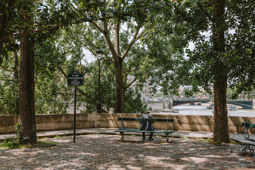 Man on Bench Along Seine