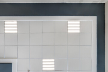 cassette stretched or suspended ceiling with square halogen spots lamps and drywall construction in...