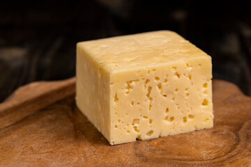 a piece of cheese with holes on the table