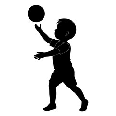Silhouette of a child playing with a ball