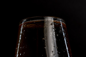 light golden beer in a glass glass on a black background