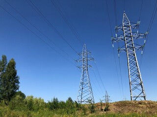 View of high voltage power lines on a sunny day